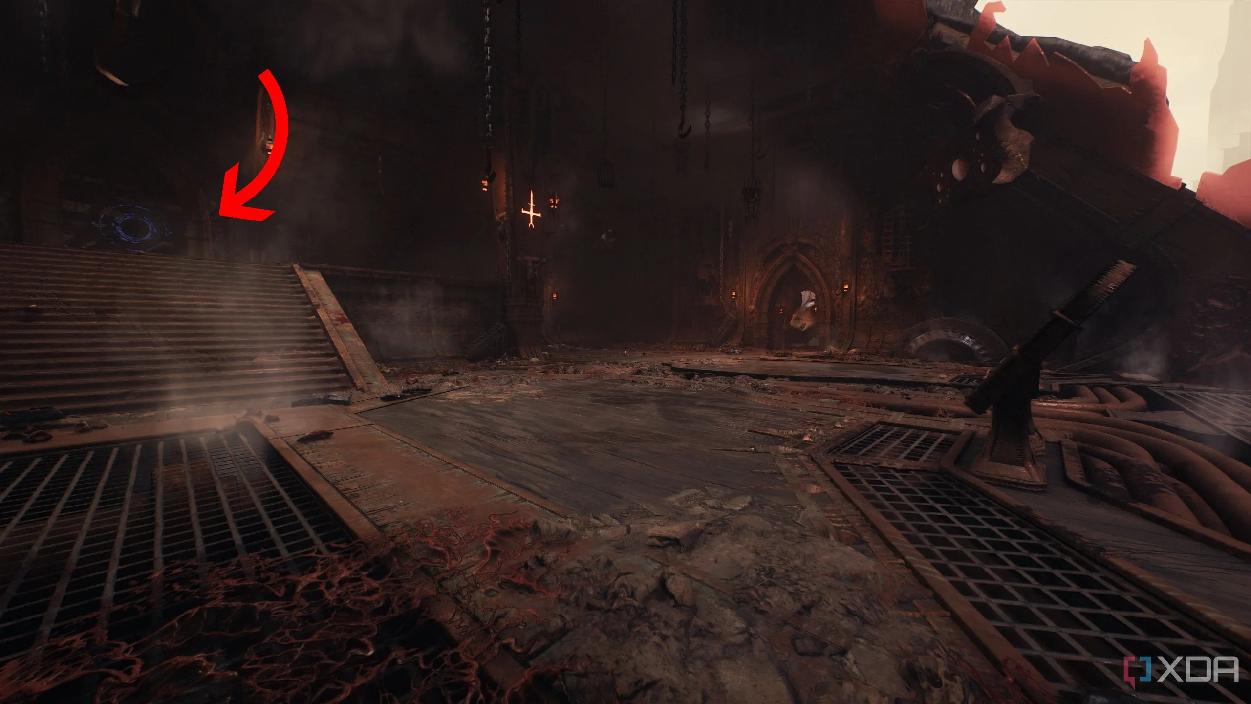 Mũi tên chỉ ra bức tường gỗ với biểu tượng Shield Bash trong con tàu Hell Carrier đã bị rơi, là lối vào một khu vực bí mật chứa hòm vàng trong Doom The Dark Ages.