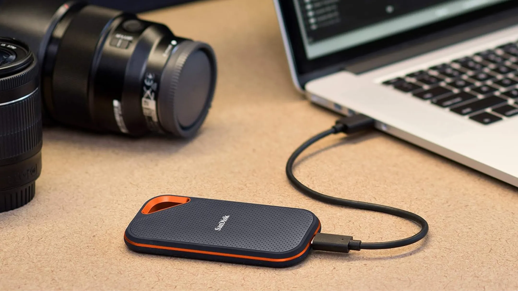 Ổ cứng SanDisk Extreme Portable SSD 8TB đặt cạnh laptop và máy ảnh, minh họa cho khả năng lưu trữ di động cho nhiếp ảnh gia và người sáng tạo
